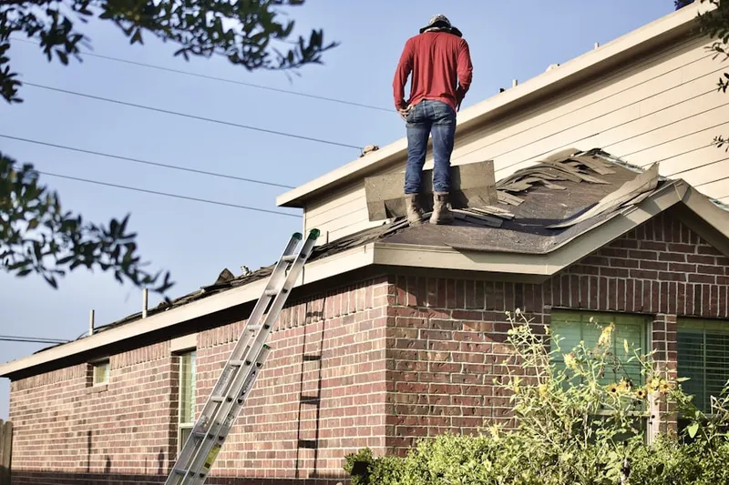 Professional roofer working on a residential roof in Lindenwald
